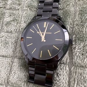 Michael Kors black and gold watch.